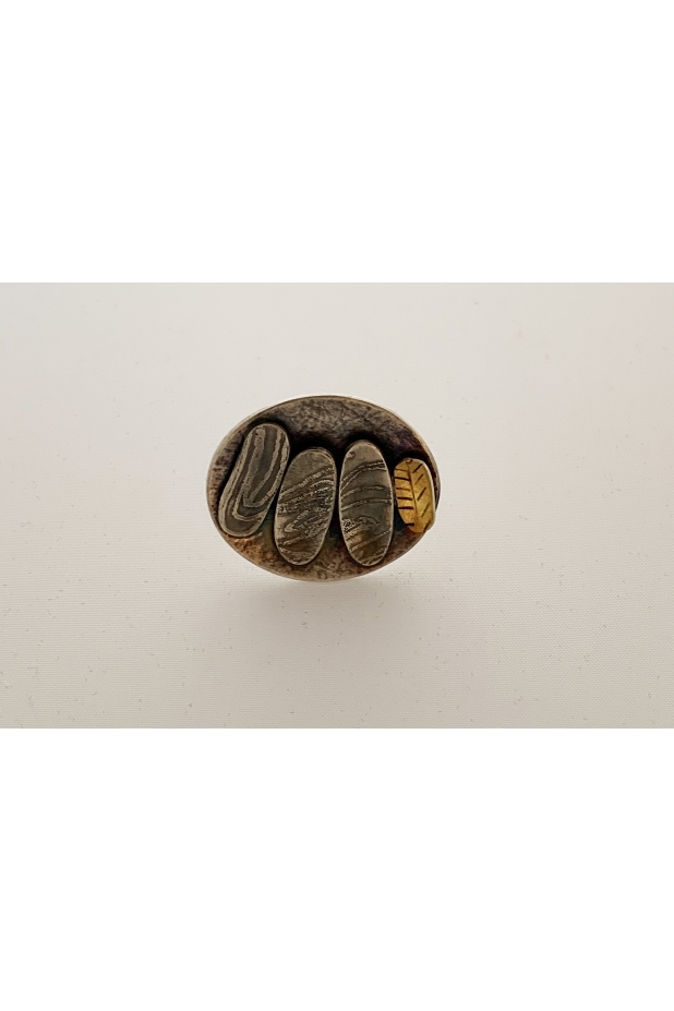 Silver and gold ring with patina.