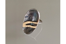 Silver and gold ring with patina.